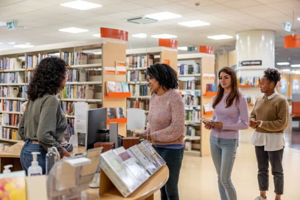 istock Latin-American Student Checking Out Books In Local College Library 1473485264