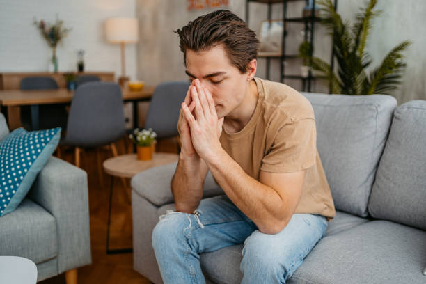 istock Sad Young Man Sitting At Home On The Sofa 1473485278