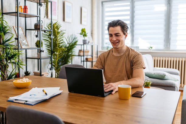 istock Young Man Working On A Laptop At Home 1473485301