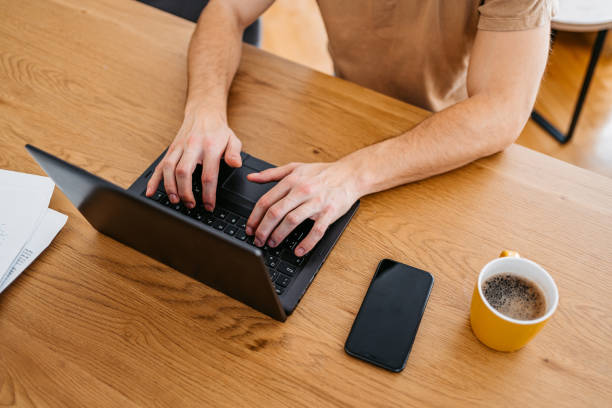 istock Young Man Working On A Laptop At Home 1473485402