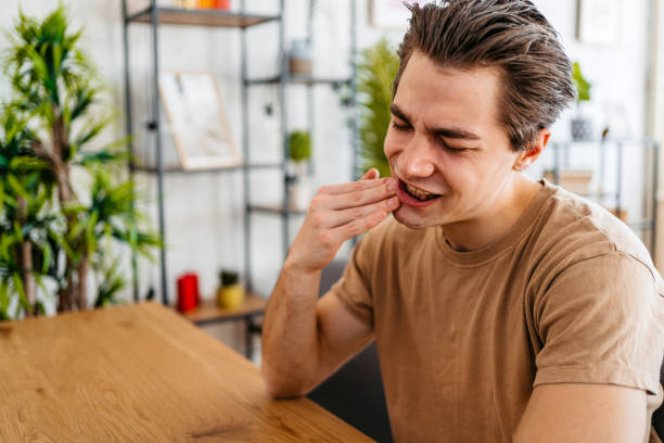 istock Young Man Having Toothache At Home 1473486230