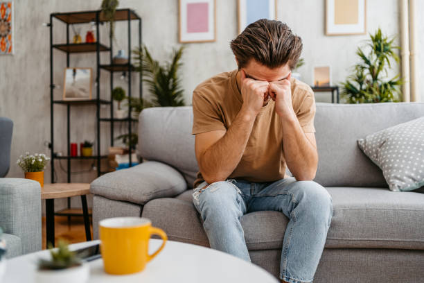 istock Sad Young Man Sitting At Home On The Sofa 1473486251
