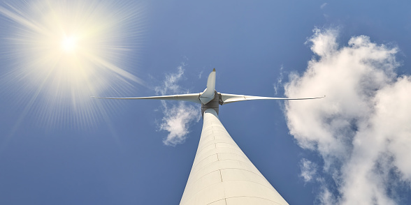 Low angle view of a Dutch wind turbine with blue sky and sunlight