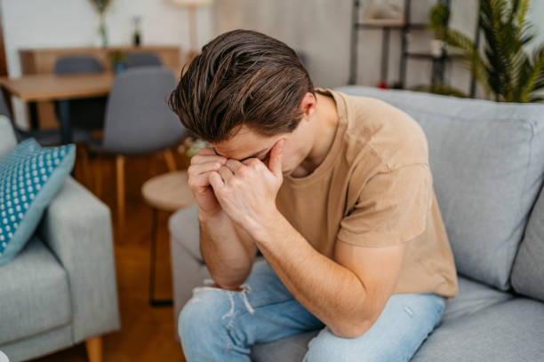 istock Sad Young Man Sitting At Home On The Sofa 1473486400