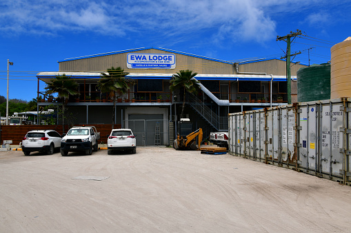 Ronave, Ewa District, Nauru: Ewa Lodge and car rental, small modern hotel on the Capelle & Partner compound - Capelle & Partner also operate a supermarket and several other businesses in this compound and in other locations on the island - shipping containers and water tanks on the right.