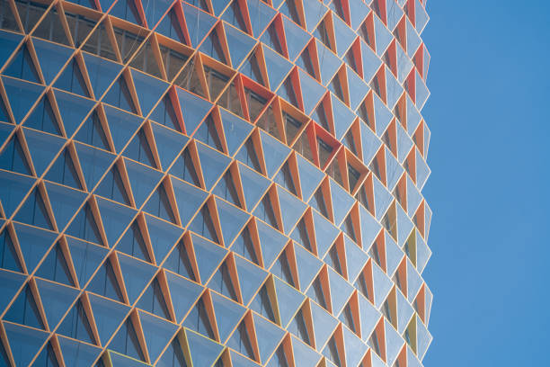 istock Modern building with colorful triangle glass windows background, on cloudy sky background. Stock photo 1473492850