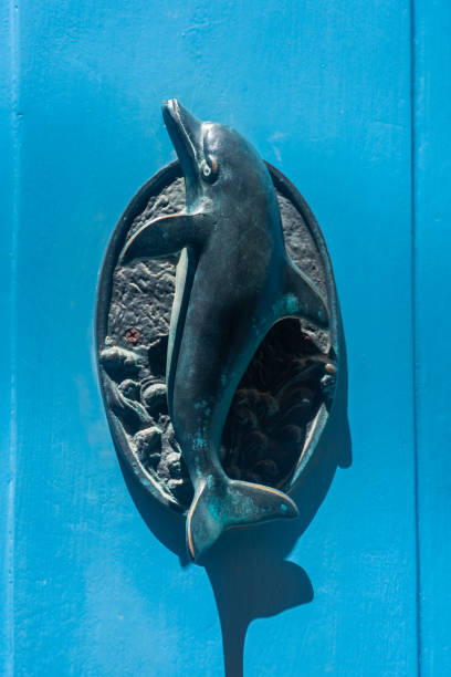 istock Typical brass dolphin door knocker on a blue door in Gozo,  Malta 1473494236