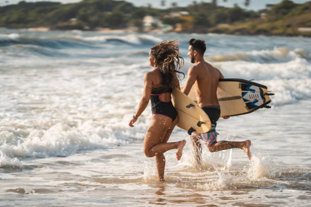 istock Surfers running in sea foam 1473495342