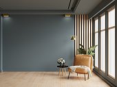 Cozy modern living room interior with leather armchair and decoration room on empty dark blue wall background.