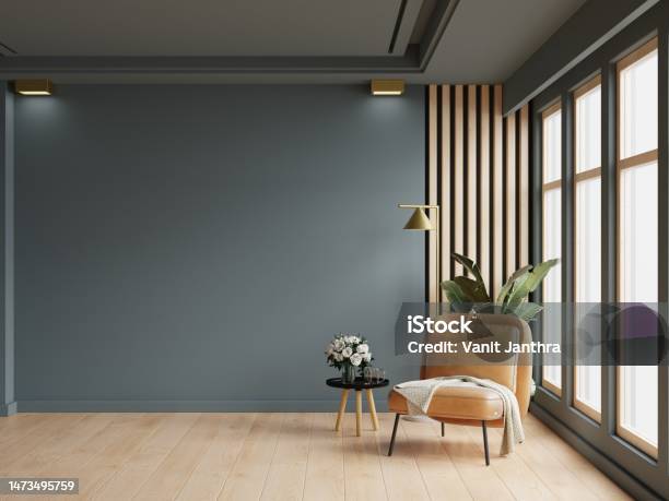 Cozy Modern Living Room Interior With Leather Armchair And Decoration Room On Empty Dark Blue Wall Background Stock Photo - Download Image Now