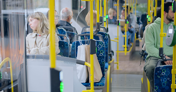 Passengers sitting while travelling in public bus.