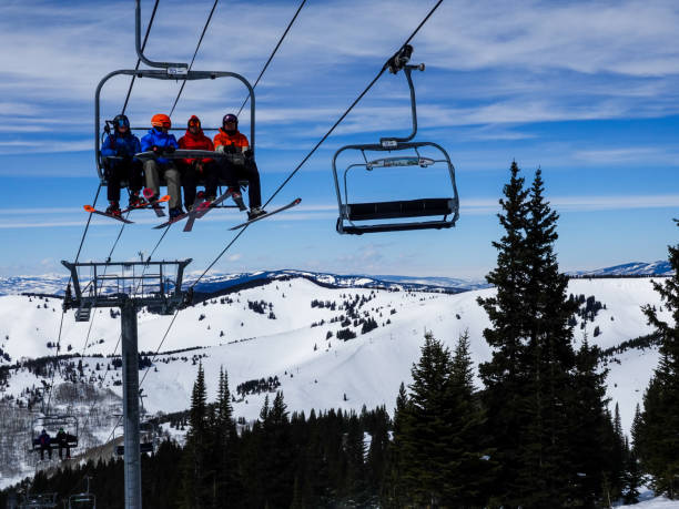 Skiers on a ski lift Blue Sky Basin area of Vail ski resort, Colorado. stock photo