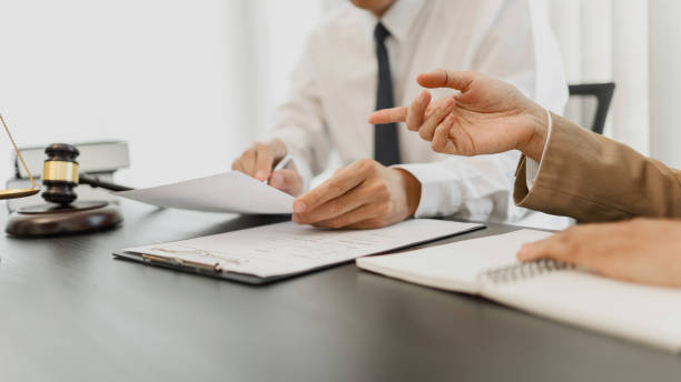 istock Counselor with legal documents discussing with client about legacy case. 1473499420