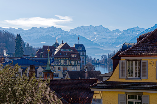 Aerial view of cityscape with river and snow covered mountains in the background. Photo taken February 21st, 2023, Thun, Switzerland.