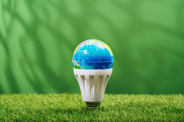 istock Globe in LED light bulb on green background. Green energy 1473500666