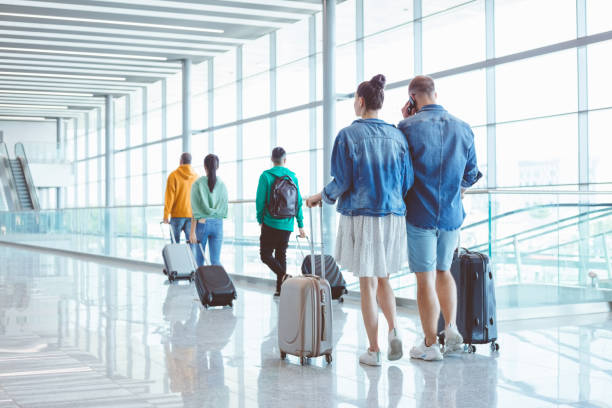 istock People with luggage at airport 1473501664