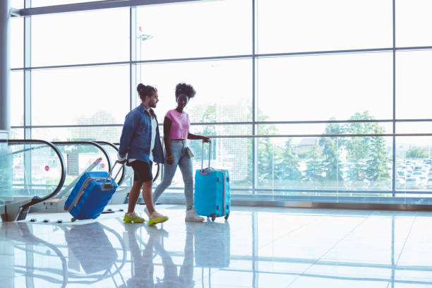 istock People with luggage at airport 1473501708