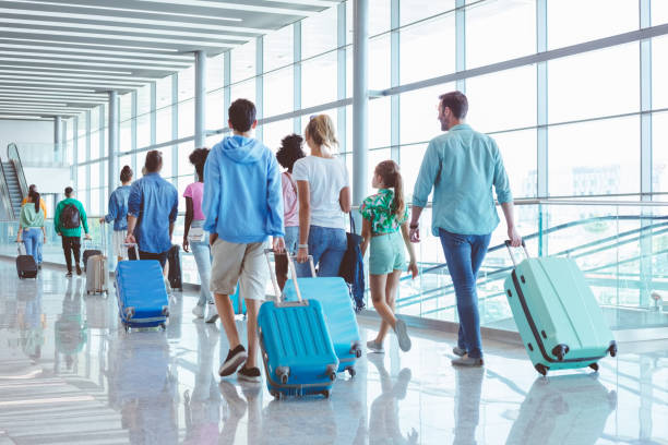 istock People with luggage at airport 1473501795