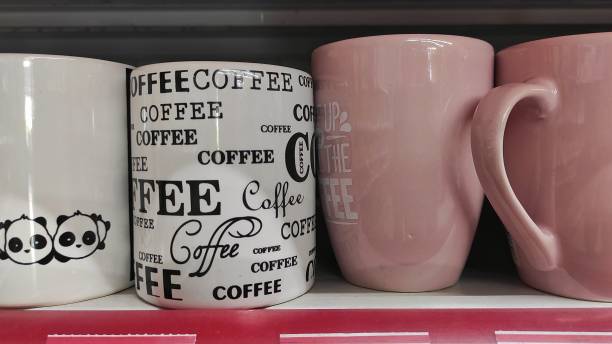 istock Pink and white ceramic mug displayed on storefront of supermarket 1473501870