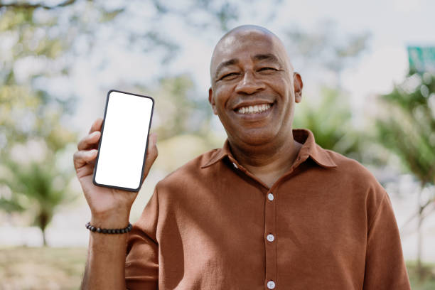 Mature man holding smartphone