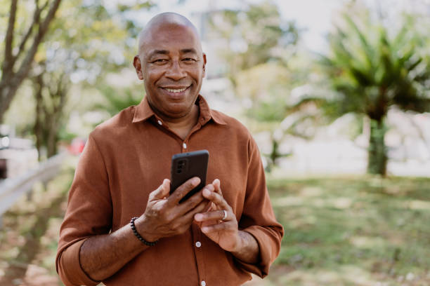 istock Mature man holding smartphone 1473501894