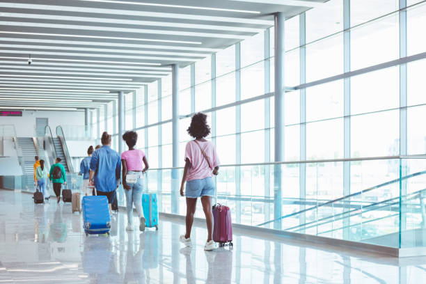 istock People with luggage at airport 1473501986