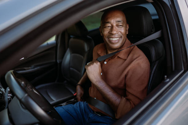 istock Male driver putting safety seat on car 1473502003