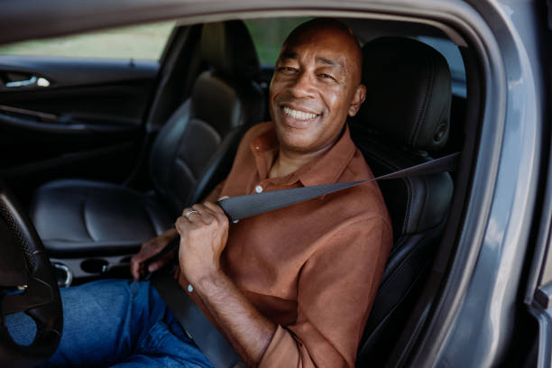 istock Male driver putting safety seat on car 1473502072