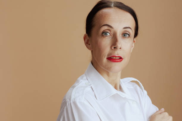 istock modern female in white shirt isolated on beige 1473502183