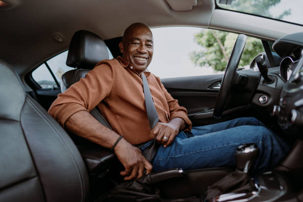 istock Male driver putting safety seat on car 1473502255