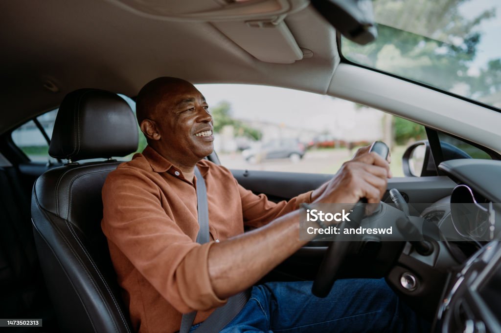 Portrait of a mature male driver in the car Driving Stock Photo
