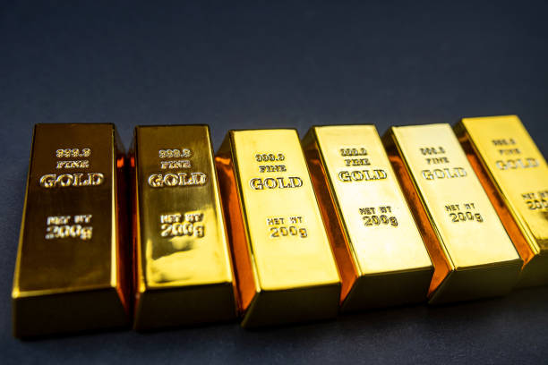 istock Stack of golden bars isolated on black background 1473502512