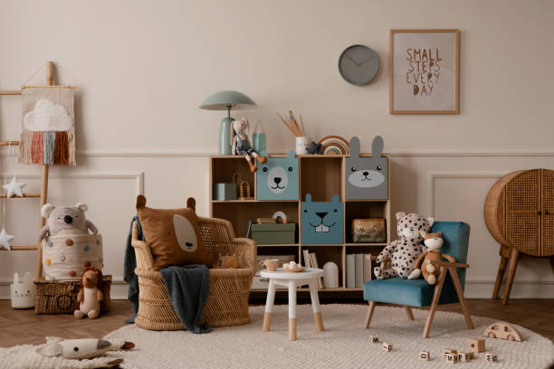 istock Creative composition of kids room interior with mock up poster frame, wall with stucco, colorful sideboard, braided armchair, plush toys, brown pillow and personal accessories. Home decor. Template. 1473503140