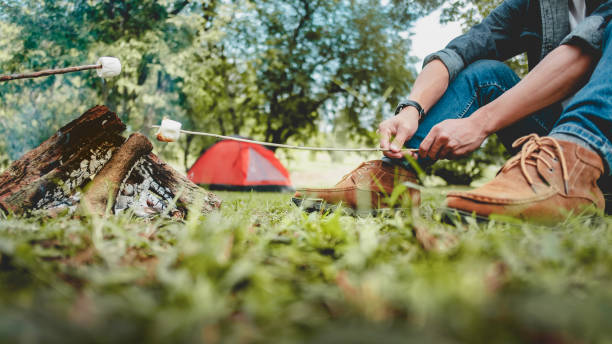 istock Man roasting marshmellow at camping in the forest. 1473505426