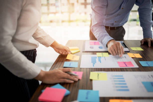 istock Startup concept, Group of young people brainstorming shared business idea. 1473505519