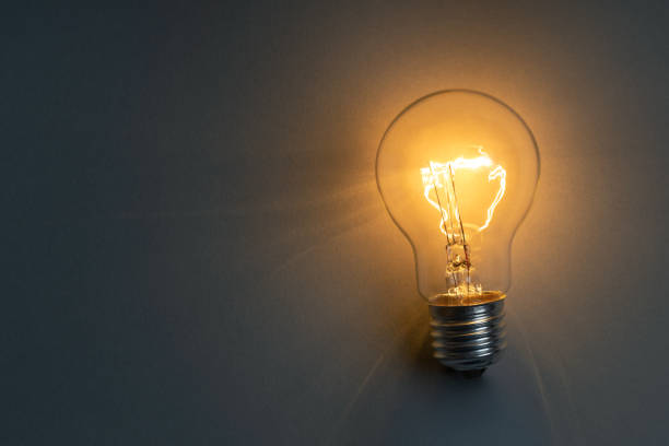 istock Idea concept with classic light bulb glowing in the dark 1473506379