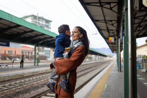 istock Mother and son waiting on a train station 1473506447