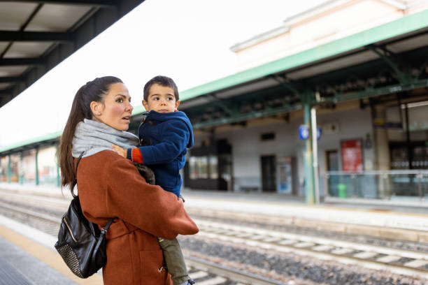 istock Mother and son waiting on a train station 1473506498