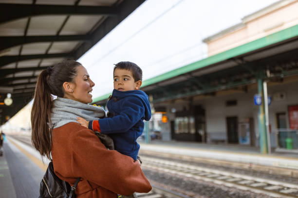 istock Mother and son waiting on a train station 1473506502