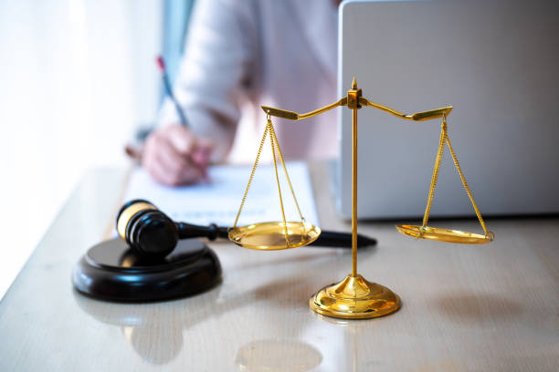 istock Lawyer writing documents in office with gavel, symbol of justice 1473506882
