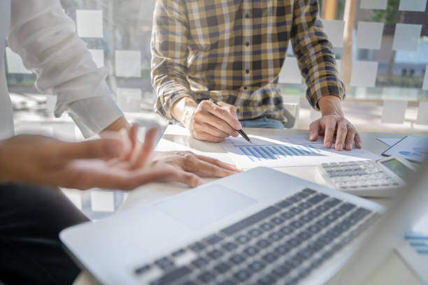 istock Startup business people teamwork calculating a valuation in workplace. 1473507805