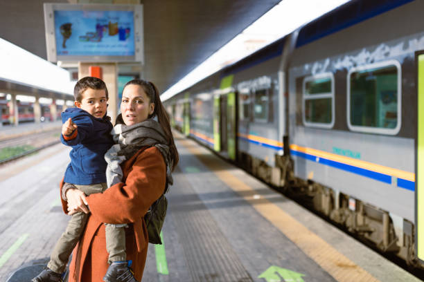 istock Mother and son waiting on a train station 1473507809
