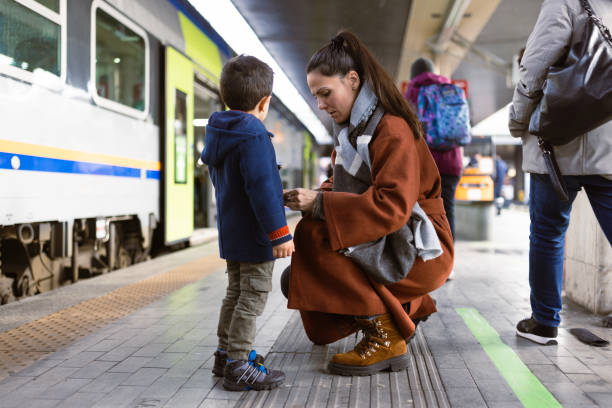 istock Mother and son waiting on a train station 1473507811