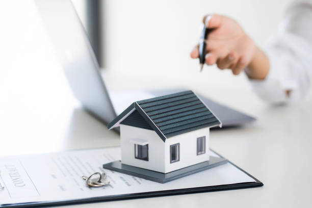 istock Real estate agent broker and customer with loan or insurance contract documents. 1473507832