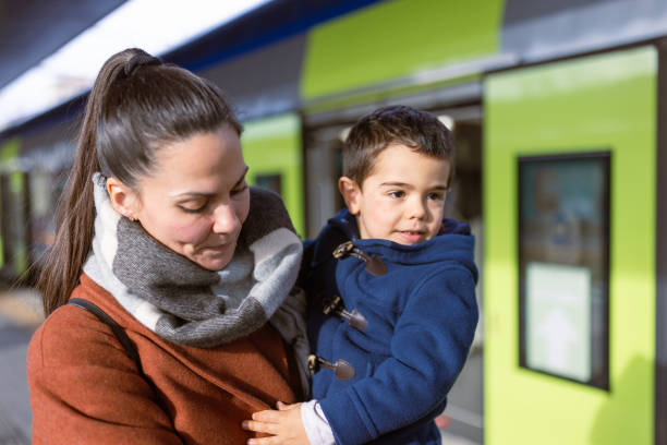 istock Mother and son waiting on a train station 1473507860