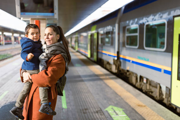 Mother and son waiting on a train station