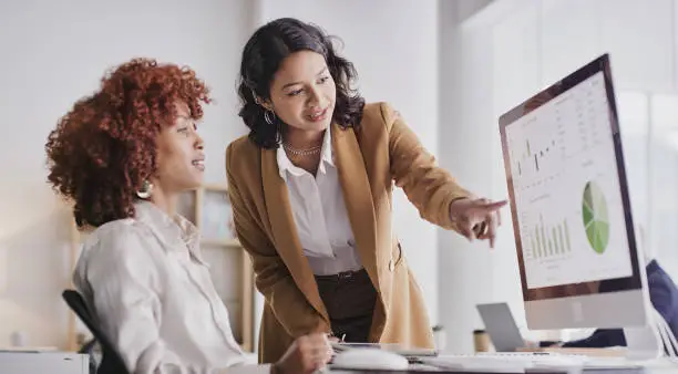 Photo of Business people, computer and analytics monitoring corporate statistics of graph or chart on screen at office. Employee women in teamwork collaboration looking at company data or analysis on PC