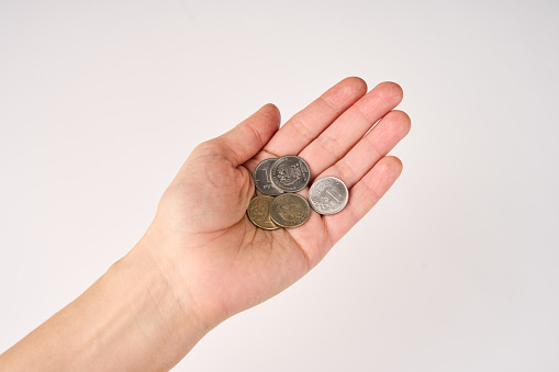 Hands holding coins money on white background. Poor woman hand with Russian coins.