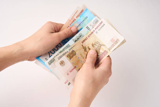 istock Hands counting Russian money bills, close-up 1473509963