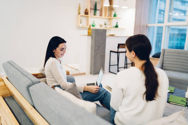 istock Women on sofa in cozy living room 1473510069